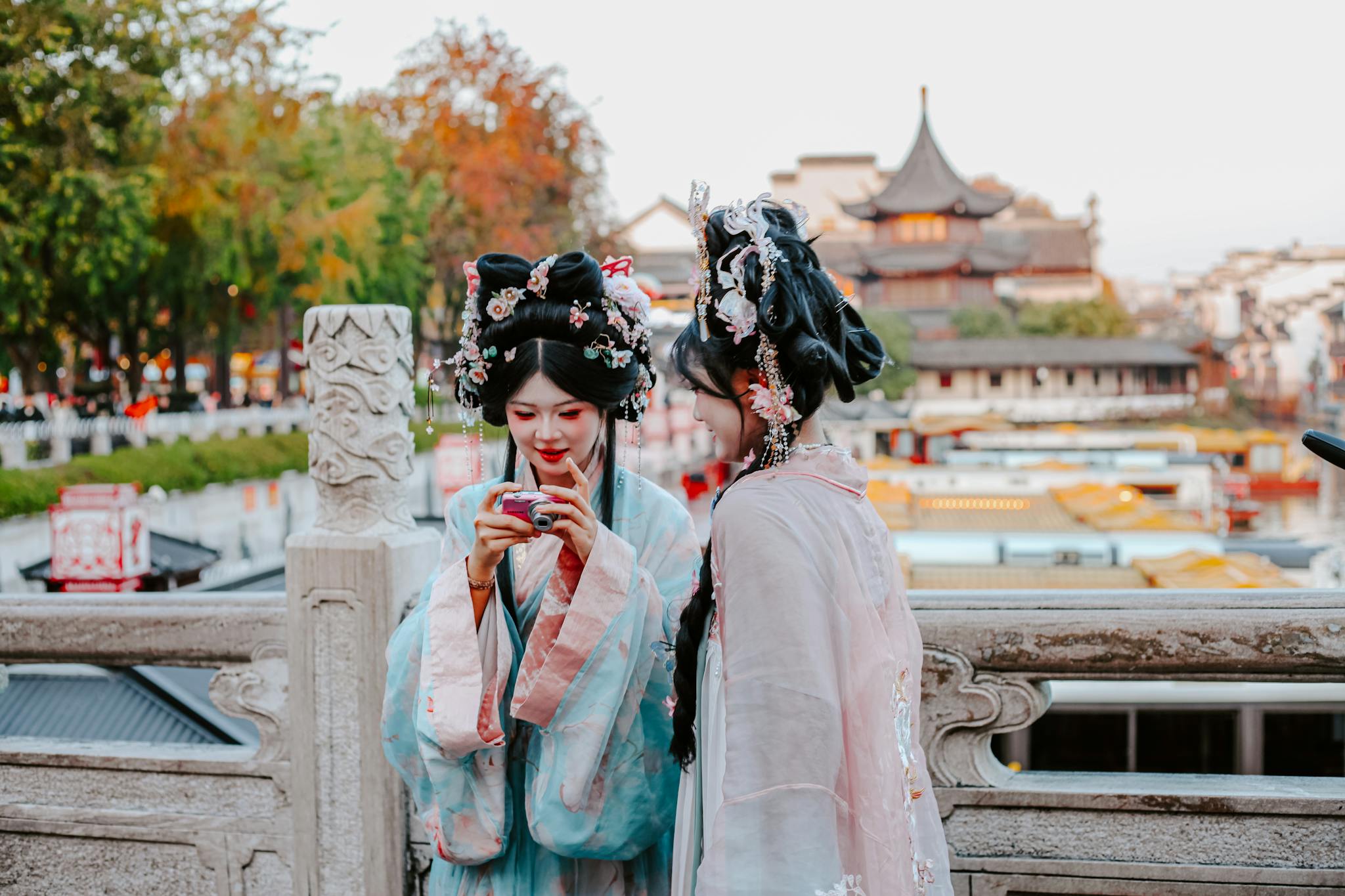 Women in traditional hanfu clothing in a scenic area of Nanjing, China.